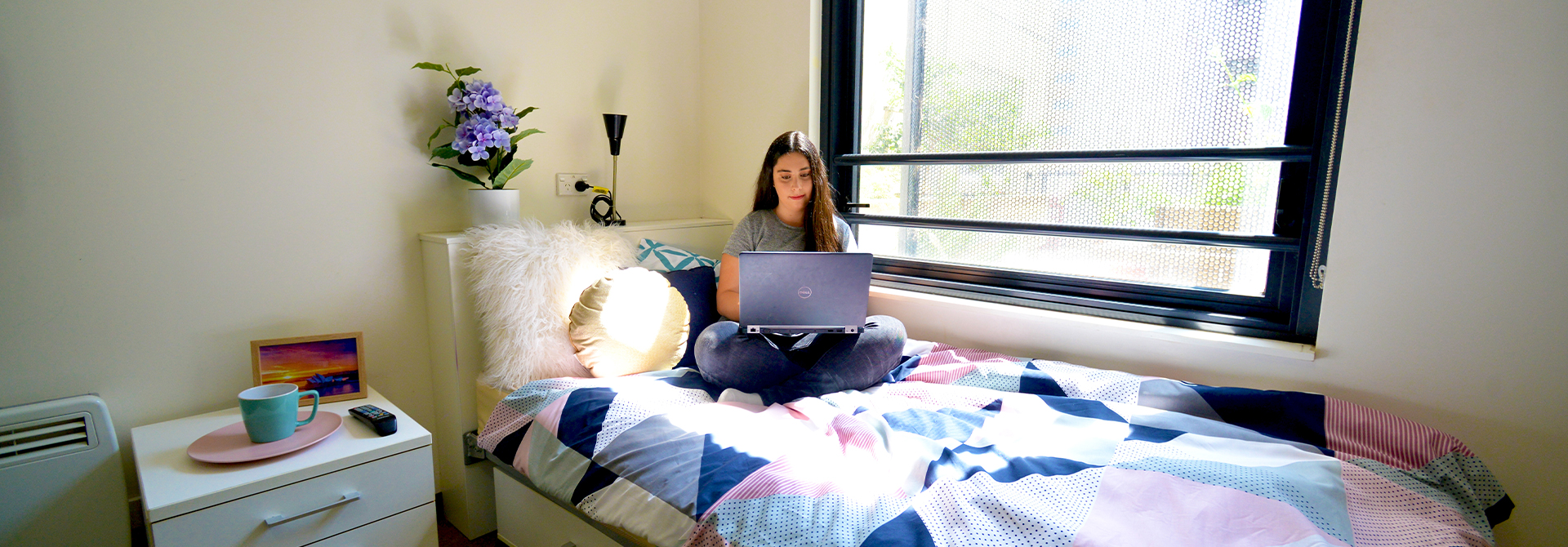 Student in UTS Accommodation using laptop